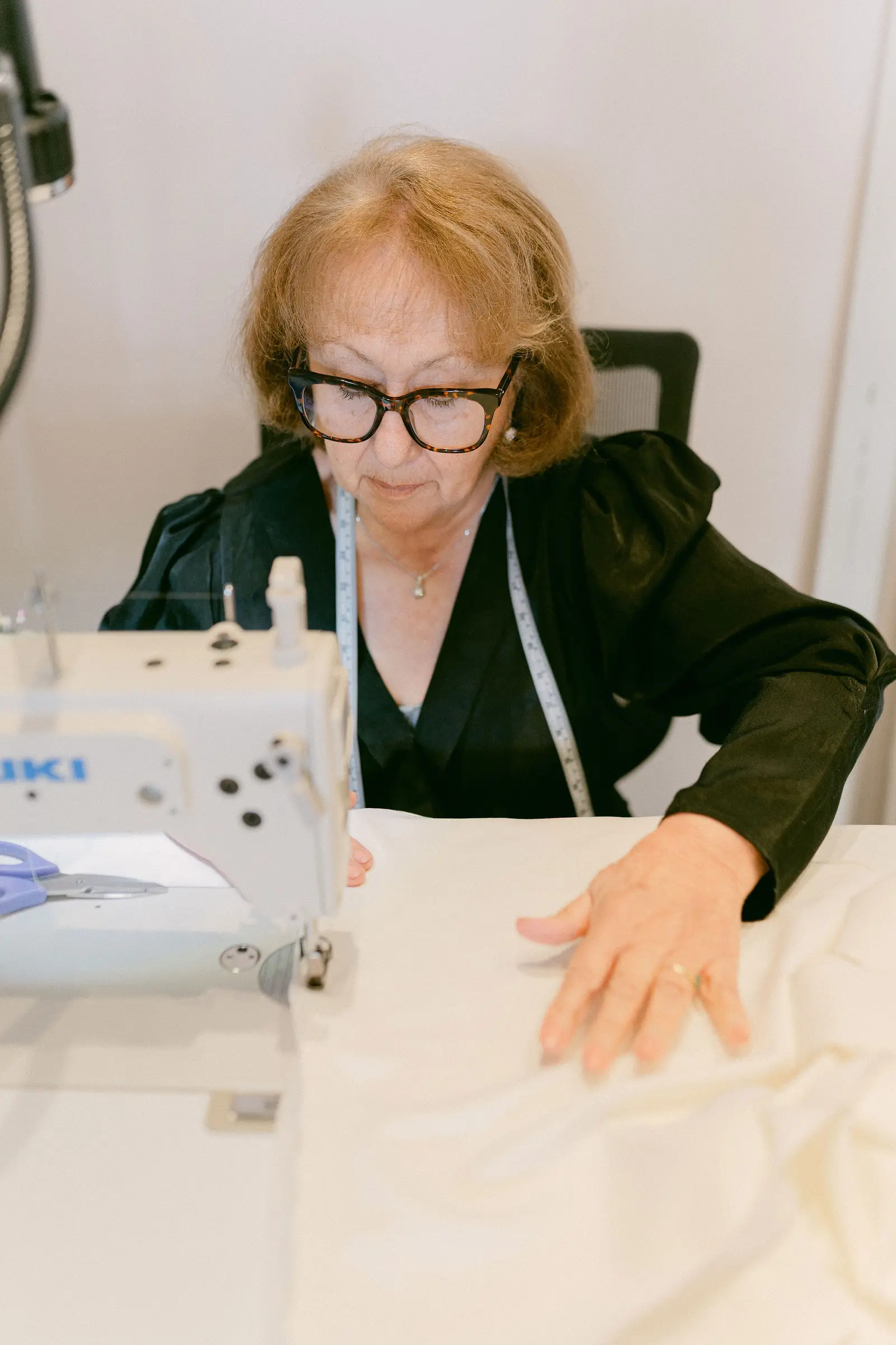 A gown being finished on the workroom floor