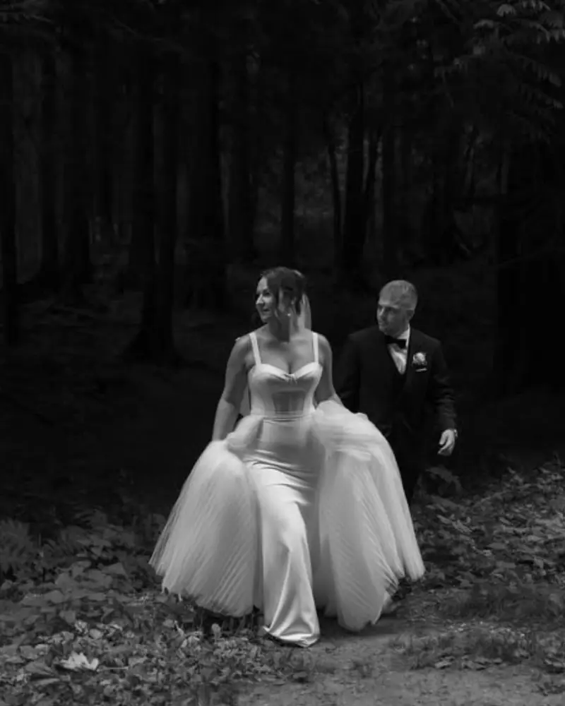 A bride photographed among trees after her ceremony