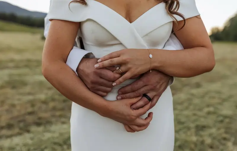 A close-up of a bride's rings and bouquet on her wedding day