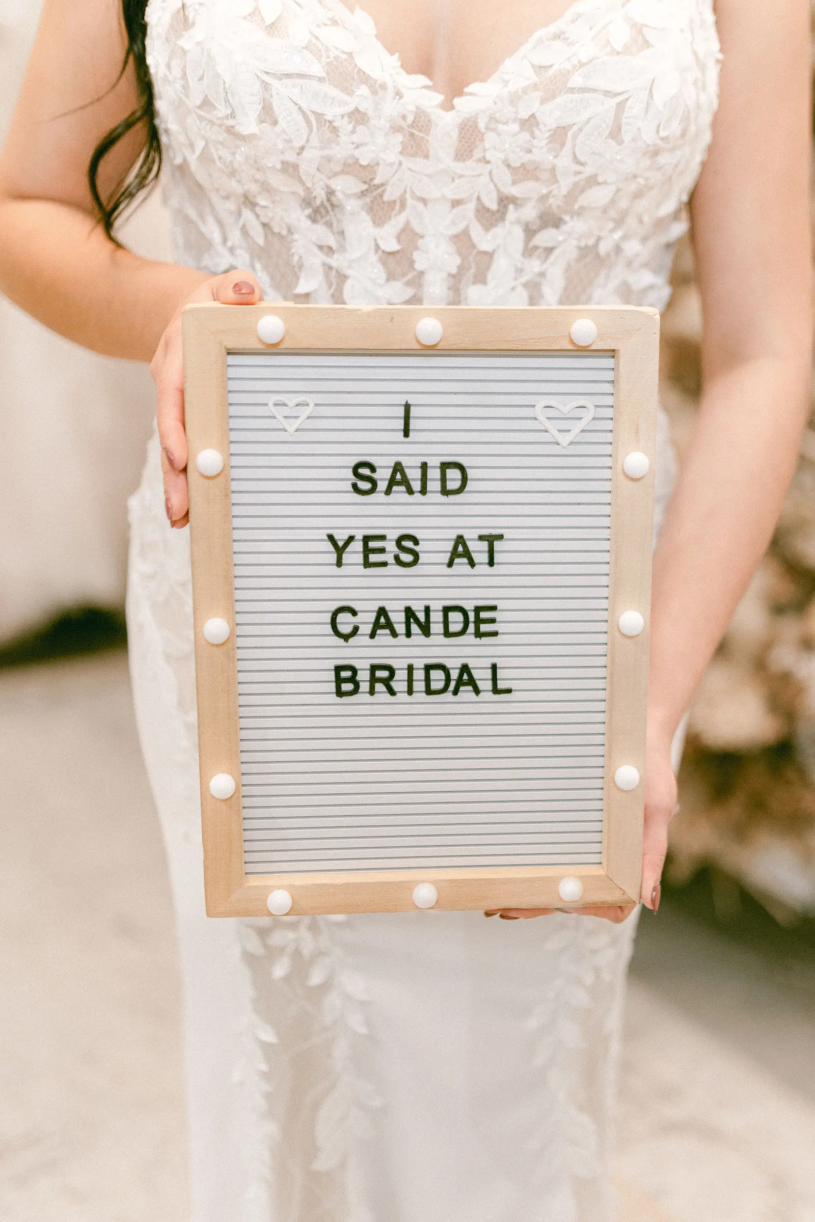 A bride standing full length in front of the mirror at the moment she chooses her gown